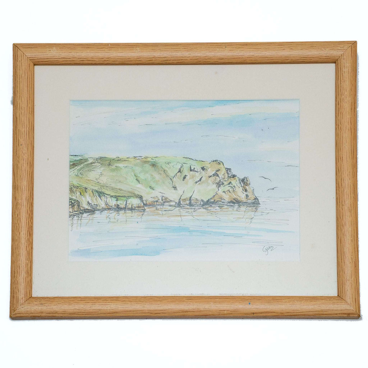 Framed pen-and-wash landscape print with sea and rocky cliffs in blue-green tones